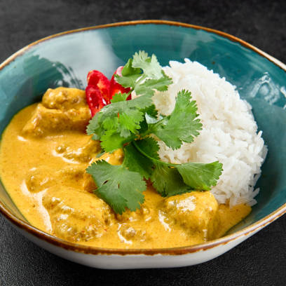 Creamy Chicken Curry with Coconut Milk served with rice in a bowl